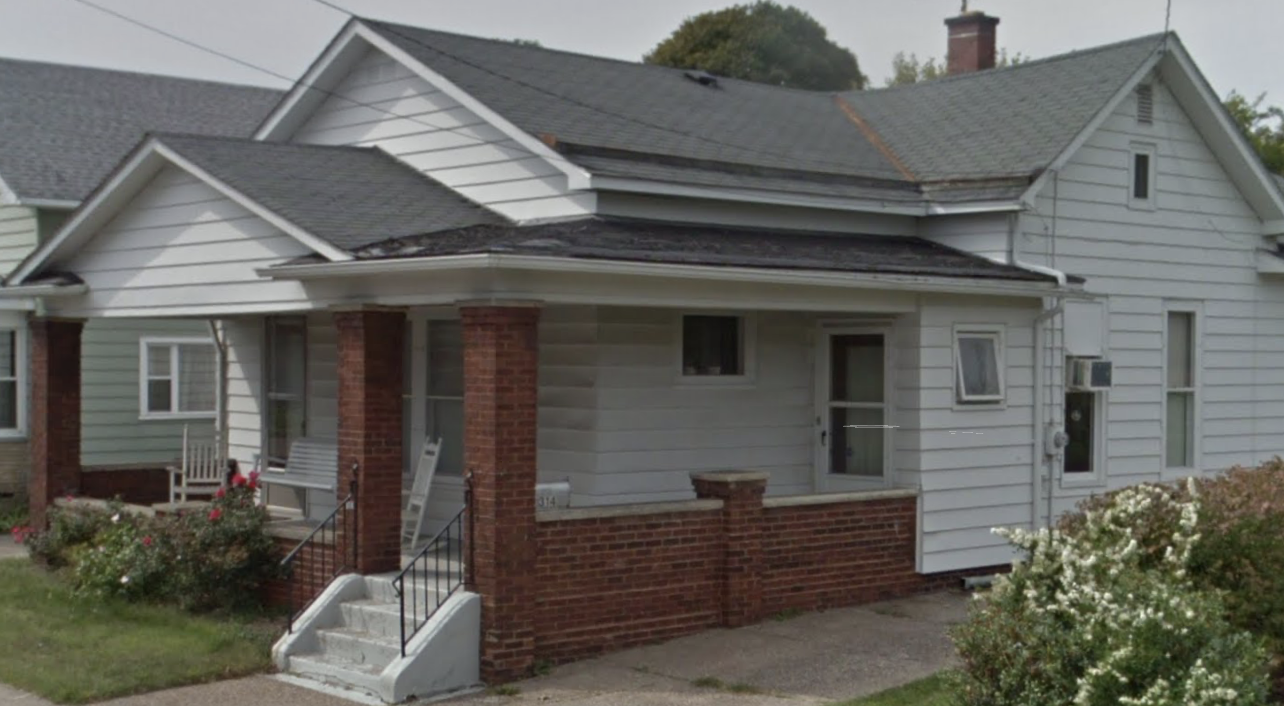 The family home on 26th Street in Erie, PA where the telegram was received. You can see the wooden vestibule door with a middle glass pane and a white fabric covering.
