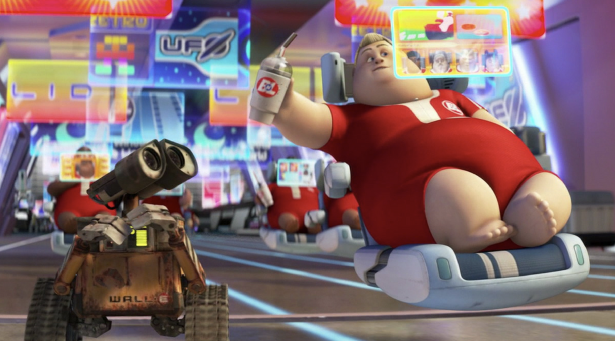 A still from the film WALL-E showing a human reclining on a hover-chair, absorbed in a screen held in front of their face.